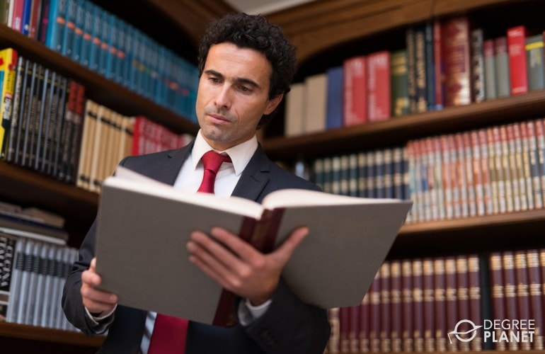 Lawyer reading a book in his office