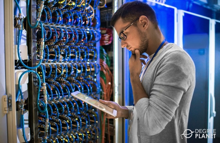 Computer and Information Research Scientist checking cables in data center
